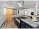 Beautiful kitchen showing granite countertops, new appliances, and a view to a pantry with a sliding barn door at 4346 10Th N Ave, St Petersburg, FL 33713