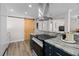 Modern kitchen showcasing granite countertops, a sliding barn door and luxury appliances at 4346 10Th N Ave, St Petersburg, FL 33713