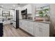 Bright kitchen features white cabinets, modern appliances, granite countertops, and wood-look flooring at 4346 10Th N Ave, St Petersburg, FL 33713