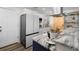 Close up of gorgeous kitchen including an island with bar stools, stainless refrigerator and granite countertops at 4346 10Th N Ave, St Petersburg, FL 33713
