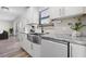 Updated kitchen features a stainless steel farmhouse sink, granite countertops, and wood-look floors at 4346 10Th N Ave, St Petersburg, FL 33713
