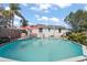 The pool is surrounded by lush greenery with a sunshade over the lounge area at 4346 10Th N Ave, St Petersburg, FL 33713
