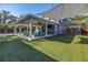 Relax in the beautiful covered outdoor area overlooking a green backyard with an inground pool at 4514 W Beachway Dr, Tampa, FL 33609