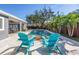 A beautiful backyard pool is surrounded by lush landscaping and two blue Adirondack chairs at 4514 W Beachway Dr, Tampa, FL 33609