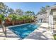 Gorgeous in-ground pool surrounded by lush landscaping and a privacy fence for relaxing days at 4514 W Beachway Dr, Tampa, FL 33609