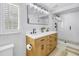 Bathroom boasts a double sink vanity, large mirror, and glass shower at 4514 W Beachway Dr, Tampa, FL 33609
