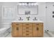 Double sink vanity in a well-lit bathroom with a walk-in shower at 4514 W Beachway Dr, Tampa, FL 33609