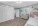 Comfortable bedroom features a large closet, a dresser, and a cozy bed at 4514 W Beachway Dr, Tampa, FL 33609