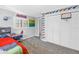 Well-lit bedroom with a double closet, sports decor and a window at 4514 W Beachway Dr, Tampa, FL 33609
