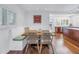 Bright dining area with a built-in bench, wooden table, and stylish chairs adjacent to the open kitchen at 4514 W Beachway Dr, Tampa, FL 33609