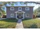 Charming two-story home with gray siding and brick accents, complemented by a lush green lawn and inviting walkway at 4514 W Beachway Dr, Tampa, FL 33609