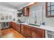 Modern kitchen area featuring cherry wood cabinets, granite countertops, and stainless steel appliances at 4514 W Beachway Dr, Tampa, FL 33609