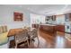 Open kitchen and dining area with wood floors, an island, and stainless steel appliances offer seamless flow at 4514 W Beachway Dr, Tampa, FL 33609