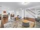 Open-concept living room with hardwood floors, stylish seating, and seamless flow into the dining area at 4514 W Beachway Dr, Tampa, FL 33609