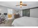 Bedroom boasts a barn door, tv, desk, and access to the primary bathroom at 4514 W Beachway Dr, Tampa, FL 33609