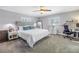 Spacious main bedroom with a fan, plantation shutters, and a desk at 4514 W Beachway Dr, Tampa, FL 33609