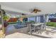 Inviting covered patio with a dining table, fan, and backyard views at 4514 W Beachway Dr, Tampa, FL 33609