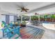 Stylish covered patio with outdoor seating, a dining area, and a view of the pool and backyard at 4514 W Beachway Dr, Tampa, FL 33609