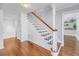 Classic staircase with wooden treads and white railings, adding a touch of elegance to the home's interior at 4514 W Beachway Dr, Tampa, FL 33609