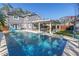 Inviting backyard oasis featuring a large swimming pool, covered patio with seating, and well-maintained lawn area at 4514 W Beachway Dr, Tampa, FL 33609