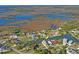 Aerial view of the neighborhood and waterfront property, showcasing its location on the canal at 5100 Cedarbrook, Hernando Beach, FL 34607
