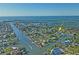 High angle aerial view of the neighborhood on the intercoastal with houses on the canal, and a boat going by at 5100 Cedarbrook, Hernando Beach, FL 34607