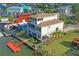 Aerial view of the two-story waterfront home featuring a dock, manicured lawn, and fenced yard at 5100 Cedarbrook, Hernando Beach, FL 34607