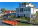The backyard showcases a private dock, fenced yard, and an outdoor spiral staircase leading to a screened balcony at 5100 Cedarbrook, Hernando Beach, FL 34607