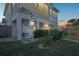 Well-maintained backyard featuring a spiral staircase to the screened in porch at dusk at 5100 Cedarbrook, Hernando Beach, FL 34607