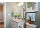 Bathroom featuring a single sink vanity with decor and a basket atop the toilet at 5100 Cedarbrook, Hernando Beach, FL 34607