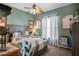 Bedroom features a patterned bedspread, neutral carpet, curtains, and a decorative ceiling fan at 5100 Cedarbrook, Hernando Beach, FL 34607