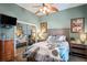 Bedroom boasts a patterned bedspread, wall mounted tv, sliding door closet and decorative ceiling fan at 5100 Cedarbrook, Hernando Beach, FL 34607