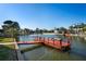 Waterfront backyard featuring a private dock with deep water access and ladder at 5100 Cedarbrook, Hernando Beach, FL 34607