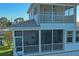 View of screened in porch and balcony overlooking the yard and waterfront at 5100 Cedarbrook, Hernando Beach, FL 34607
