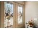 Elegant front doors with decorative glass panels, complemented by a small table and floral arrangement at 5100 Cedarbrook, Hernando Beach, FL 34607