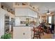 Spacious kitchen with white cabinets, stainless steel appliances, breakfast bar, and view into the dining area at 5100 Cedarbrook, Hernando Beach, FL 34607