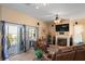 Comfortable living area featuring a fireplace, sliding glass doors to a balcony, and cozy seating at 5100 Cedarbrook, Hernando Beach, FL 34607