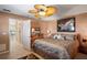 Comfortable main bedroom featuring neutral decor, a ceiling fan, and an ensuite bathroom at 5100 Cedarbrook, Hernando Beach, FL 34607