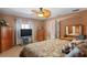 Cozy main bedroom with neutral color scheme, ceiling fan, and a dresser with a mirror at 5100 Cedarbrook, Hernando Beach, FL 34607