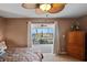 Main bedroom with neutral tones, a ceiling fan, and a view of the screened in Lanai at 5100 Cedarbrook, Hernando Beach, FL 34607
