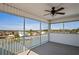 Enclosed patio with railing, a ceiling fan, and views of the channel and houses at 5100 Cedarbrook, Hernando Beach, FL 34607