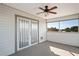 Enclosed patio featuring a ceiling fan, access doors, and a view of the backyard and sky at 5100 Cedarbrook, Hernando Beach, FL 34607