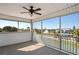 Screened patio with a ceiling fan, railing, and views of the water and neighboring houses at 5100 Cedarbrook, Hernando Beach, FL 34607