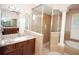 This bathroom features double sink vanity, glass shower, and soaking tub at 5115 Abisher Wood Ln, Brandon, FL 33511