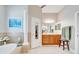 Bright bathroom featuring a soaking tub, vanity, and a walk-in closet at 5115 Abisher Wood Ln, Brandon, FL 33511