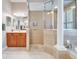 Luxurious bathroom featuring a tiled shower, dual sinks, and a soaking tub at 5115 Abisher Wood Ln, Brandon, FL 33511