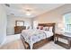 Cozy bedroom features comfortable bed, dresser, and natural light from a nearby window at 5115 Abisher Wood Ln, Brandon, FL 33511