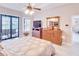 Cozy main bedroom features a ceiling fan, outdoor view, and neutral color palette at 5115 Abisher Wood Ln, Brandon, FL 33511