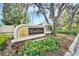 Welcome to River Woods! Beautiful community sign surrounded by flowers and lush greenery at 5115 Abisher Wood Ln, Brandon, FL 33511