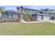Charming two-story home with three-car garage, stone accents, manicured lawn and colorful landscaping at 5115 Abisher Wood Ln, Brandon, FL 33511